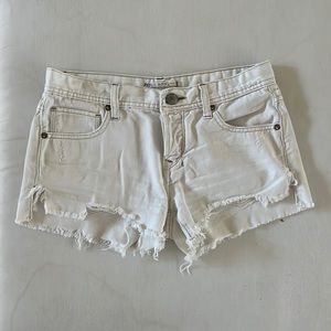 Free People distressed white denim shorts